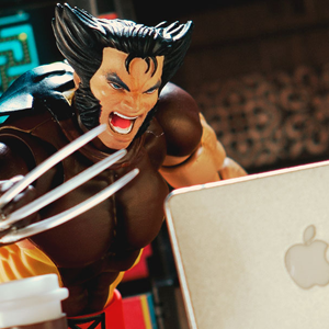 Mafex Wolverine sits at a computer with claws popped in this toy photo