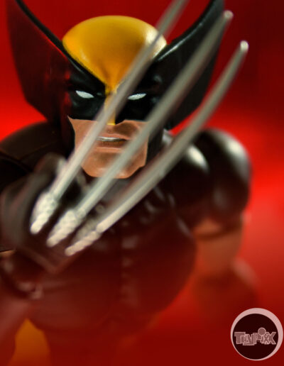 Mafex Wolverine stands, claws drawn, mocking the viewer in this toy photo